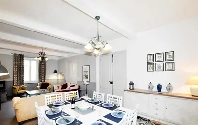a dining room and living room with a table and chairs at Gorgeous Home In Thézan-Des-Corbières in Thézan-des-Corbières