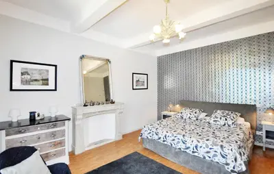 a bedroom with a bed and a dresser and a mirror at Gorgeous Home In Thézan-Des-Corbières in Thézan-des-Corbières