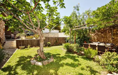 a garden with a tree in the middle of a yard at Gorgeous Home In Thézan-Des-Corbières in Thézan-des-Corbières