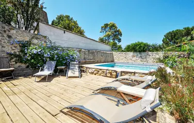 a deck with chairs and a swimming pool at Gorgeous Home In Thézan-Des-Corbières in Thézan-des-Corbières