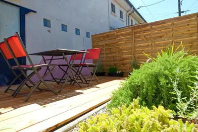 two chairs and a table on a wooden deck at Le Logis d'Aude in Carcassonne