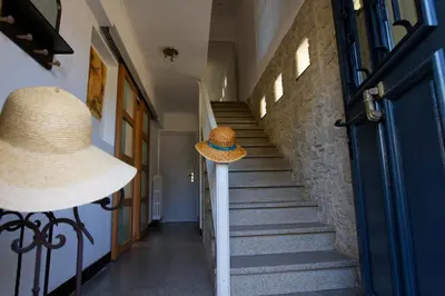 two hats sitting on a pole next to a staircase at Le Logis d'Aude in Carcassonne