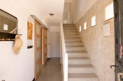 a staircase in a house with a stone wall at Le Logis d'Aude in Carcassonne
