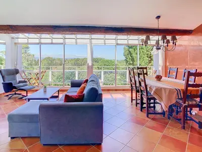 a living room with a couch and a table at Le Héron Cendré - Appartement avec vue in La Redorte