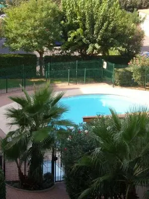 an overhead view of a swimming pool with palm trees at 150 MARINA BAY CAP D'AGDE Quartier Falaises proche plage T2 cabine avec place de parking et piscine in Laure-Minervois