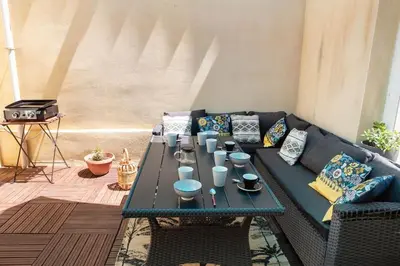 a living room with a couch and a table at Duplex moderne centre Narbonne in Narbonne