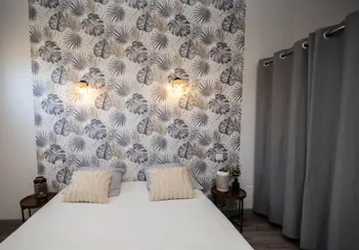 a white bed with two pillows in a bedroom at Duplex moderne centre Narbonne in Narbonne