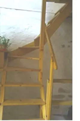 a wooden ladder leading up to a bunk bed at Petit gite rustique et économique in Albas