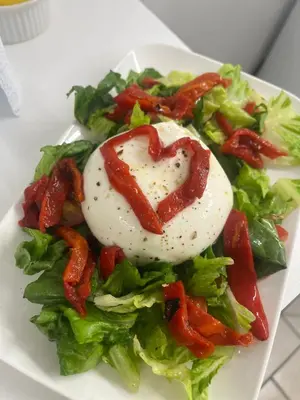 a plate of food with a heart shaped egg on a salad at Cottage atypique avec piscine & accès au lac 6 personnes in Molleville
