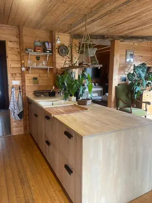 a kitchen with a large island in a room at Cottage atypique avec piscine & accès au lac 6 personnes in Molleville