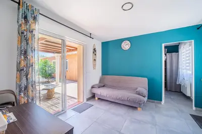 a living room with a couch and a table at Casa Sacha - Appt avec piscine partagée in Fitou