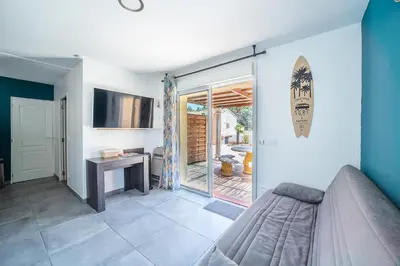 a bedroom with a bed and a sliding glass door at Casa Sacha - Appt avec piscine partagée in Fitou