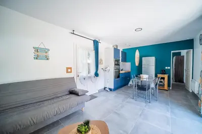 a living room with a couch and a table at Casa Jade - Appt pour 4 in Fitou
