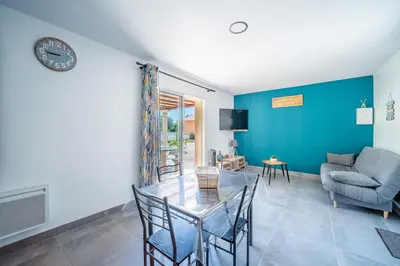 a living room with a glass table and a couch at Casa Jade - Appt pour 4 in Fitou