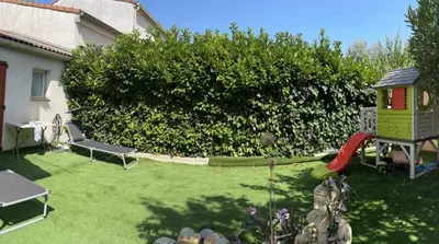 a backyard with a play yard with a playground at Studio jacuzzi à l'abri des vents in Carcassonne