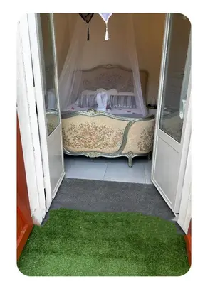 an open door with a bed in a room at CARCASSONNE Studio avec Jacuzzi y piscina in Carcassonne