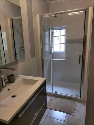 a bathroom with a shower and a sink at Appartement le petit bonheur in Saint-Pons-de-Thomières