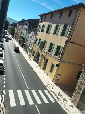 an empty street with a crosswalk in a city at Appartement le petit bonheur in Saint-Pons-de-Thomières