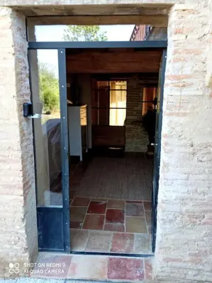 an entrance to a building with a door open at Maison Lauraguaise parking grand jardin wifi in Villenouvelle