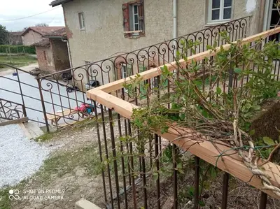 a iron fence in front of a house at Maison Lauraguaise parking grand jardin wifi in Villenouvelle