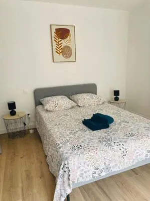 a bedroom with a bed with a blue shirt on it at Le Bastide l 2 chambres l Rez-de-chaussée l Terrasse l Clim in Sémalens