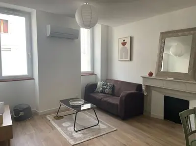 a living room with a couch and a fireplace at Le Bastide l 2 chambres l Rez-de-chaussée l Terrasse l Clim in Sémalens
