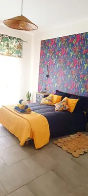 a bedroom with a large bed with a yellow blanket at A L' Estiu in Latour-de-France