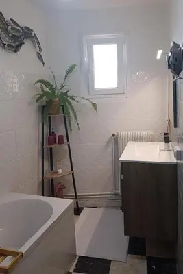 a bathroom with a tub and a sink and a window at A L' Estiu in Latour-de-France