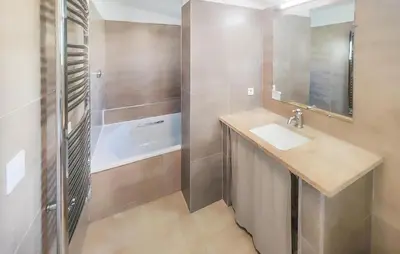 a bathroom with a sink and a bath tub at Pet Friendly Home In Saint Laurent De La Ca in Saint-Laurent-de-la-Cabrerisse