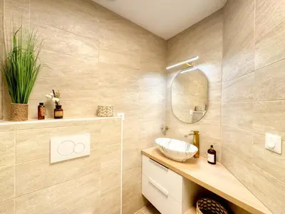 a bathroom with a sink and a mirror at Le Jardin de la Cathédrale - T2 - Centre Ville - Emplacement & Vue Extraordinaires in Narbonne