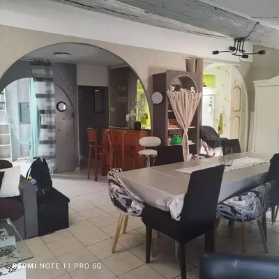 a dining room and living room with a table and chairs at Charmant T3 de 65 m2 in Port-la-Nouvelle