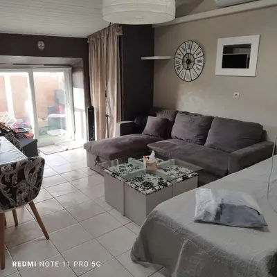 a living room with a couch and a table at Charmant T3 de 65 m2 in Port-la-Nouvelle
