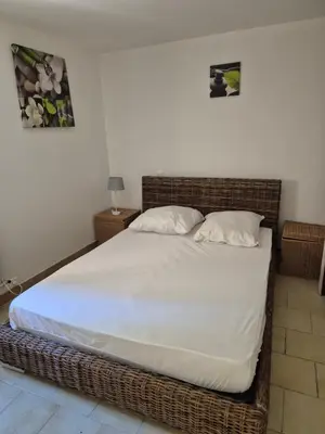 a bedroom with a large bed with white sheets and pillows at Gîte rural 8 à 10 personnes au coeur du Parc National du Haut Languedoc in Saint-Pons-de-Thomières