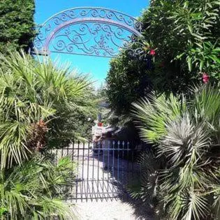 a gate in front of a garden with plants at Villa Angel - SPA in Caunes-Minervois
