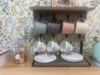 a shelf with plates and pots and pans on it at Appartement cosy avec oasis privée, salle de jeux, vélos bienvenus in Carcassonne