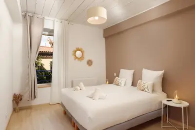 a bedroom with a white bed and a window at L impasse d'Anaïs Free Parking in Carcassonne