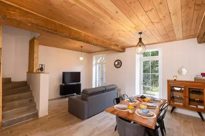 a living room with a table and a couch at L impasse d'Anaïs Free Parking in Carcassonne