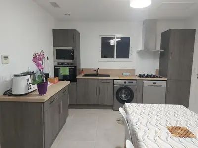 a kitchen with a washer and dryer in it at La Gourgotte in Ajac