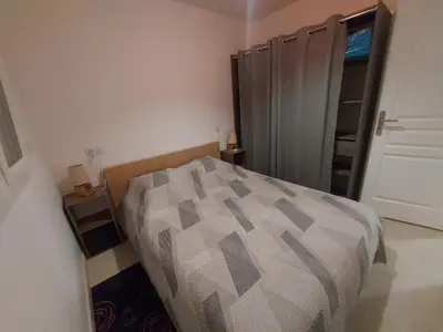 a bedroom with a bed and a closet at La Gourgotte in Ajac
