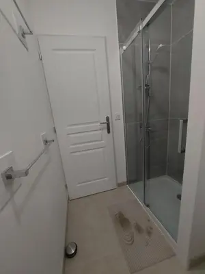 a bathroom with a shower and a glass door at La Gourgotte in Ajac