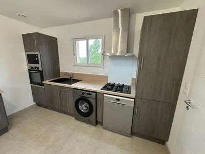 a kitchen with a stove and a dishwasher in it at La Gourgotte in Ajac