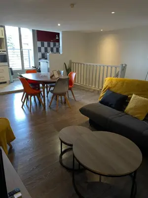 a living room with a couch and a table at Chez Pauline & Vincent Côté Canal in Carcassonne