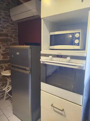 a microwave sitting on top of an oven at Chez Pauline & Vincent Côté Canal in Carcassonne