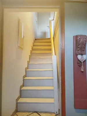 a staircase leading up to a room with a door at Chez Pauline & Vincent Côté Canal in Carcassonne