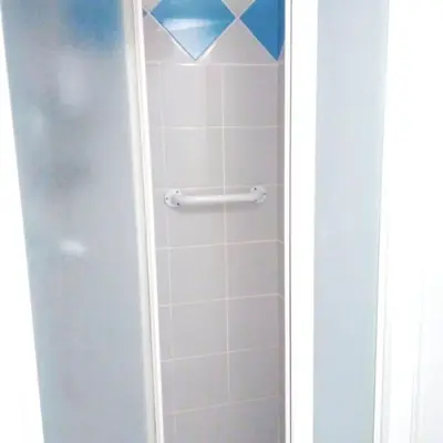 a shower with a glass door in a bathroom at Appartement du bonheur- 6 personnes in Gruissan