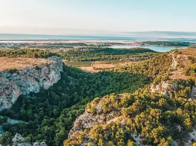 an aerial view of a canyon with trees and water at Appartement du bonheur- 6 personnes in Gruissan