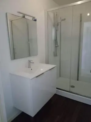 a white bathroom with a sink and a shower at Maison indépendante à la ferme in Palleville
