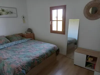 a bedroom with a bed and a window and a mirror at Maison indépendante à la ferme in Palleville