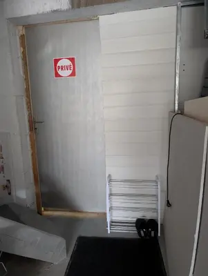 a garage door with a dmg sign on it at Studio indépendant tout équipé in Saint-Marcel