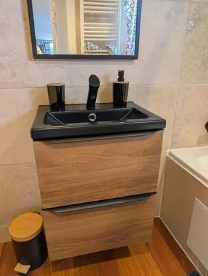a bathroom with a black sink and a mirror at Studio indépendant tout équipé in Saint-Marcel